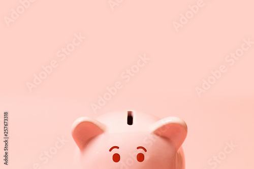 Piggy bank on living coral background. Commercial concept. Commercial concept.Top view point, flat lay. photo