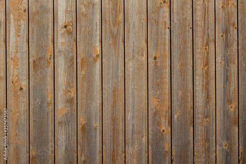 gray yellow fence of dry boards. rough surface texture