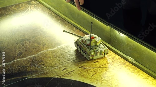 scale model miltary tank with camouflage moving on play board photo