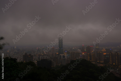 Taipei 101 modern city building with cloud rain at dusk