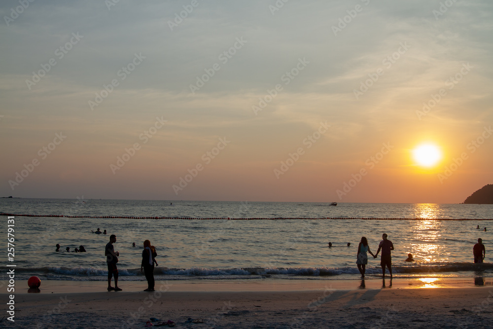 silhouette of couple on the beach at sunset silhouette of couple on the beach at sunset