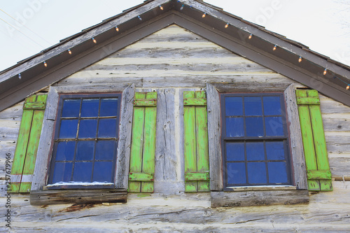 Old roof with two windows and Christmas lights. photo