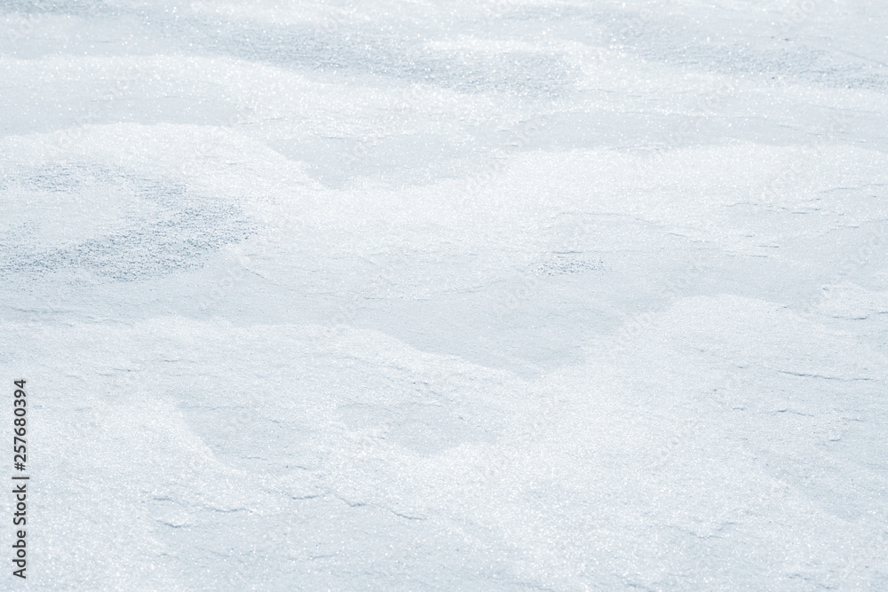 Fresh snow background texture. Winter background with snowflakes and snow mounds. Snow lumps.