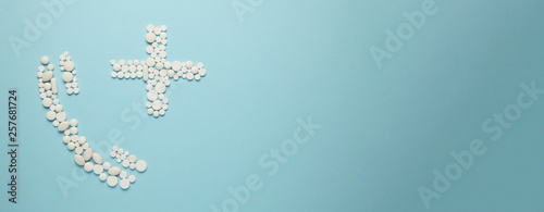 Telephone receiver and cross of pills on blue background. Call doctor, the concept of medical care. © Andrii Zastrozhnov