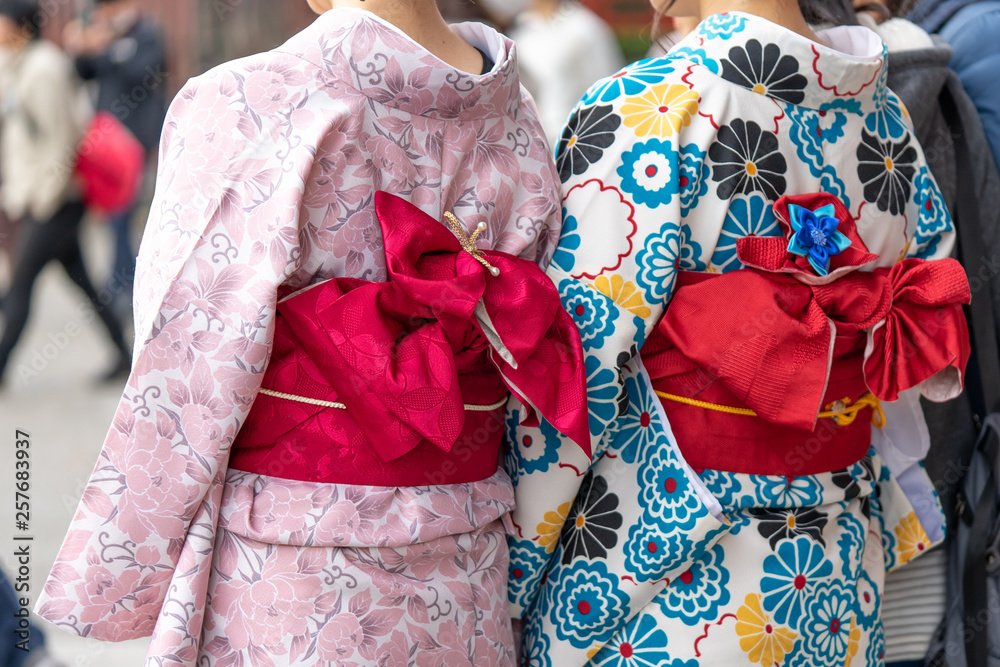 Young girl wearing Japanese kimono standing in front of Sensoji Temple in Tokyo, Japan. Kimono is a Japanese traditional garment. The word 