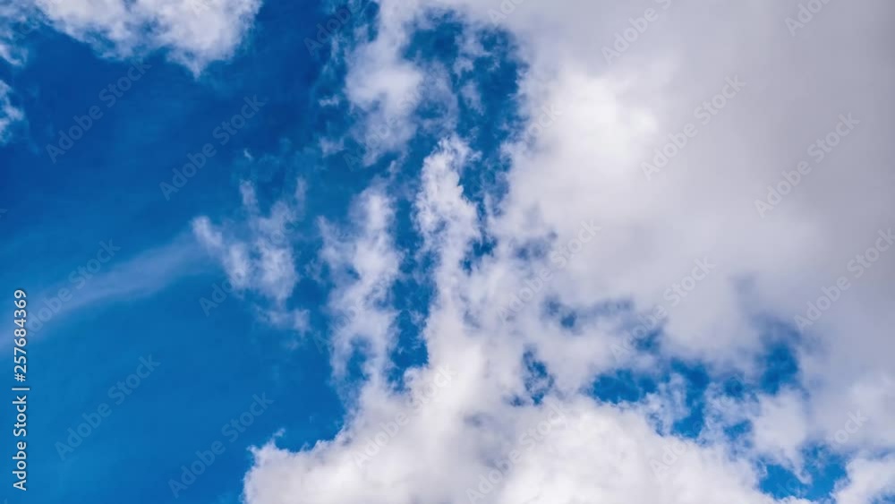 White clouds moving on a blue sky background time lapse White clouds moving on a blue sky background time lapse