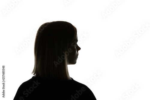 Silhouette of woman looking away isolated on white