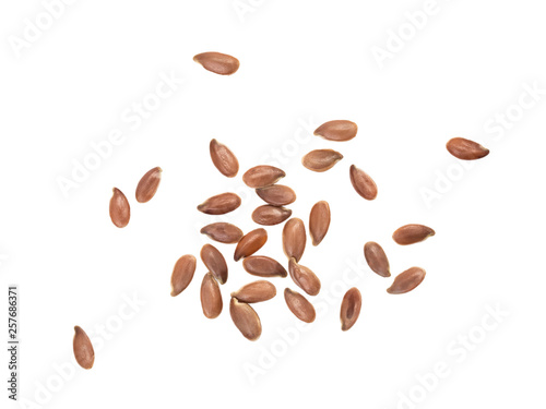 Some spread out linseeds or flax seeds seen directly from above and isolated on white background