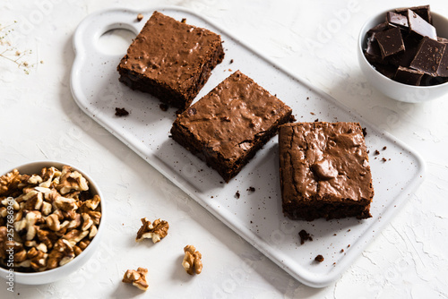 Homemade dark chocolate brownies on white table. Delicious bitter sweet and fudge. Chocolate cake