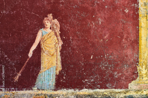 Figure of a woman painted in a Fresco in a Domus of Pompeii, Italy photo