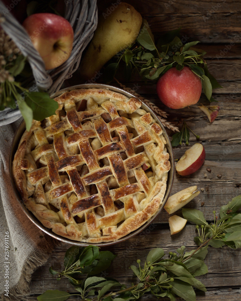 Apple pie in copper form. Apples and field flowers in old basket. Rustic style Apple pie in copper form. Apples and field flowers in old basket. Rustic style