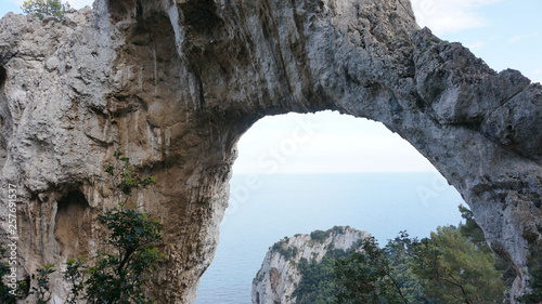Hole in a rock, cliff on a hiking path at the mediterranean coast of capri