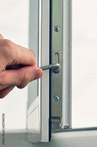 Workman adjusts the operation of the plastic window.