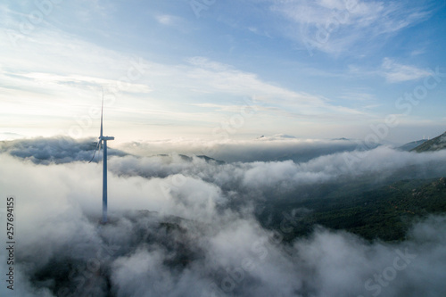 Wind power generator before sunrise sunset ，Wind power generation in the sea of clouds