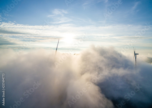 Wind power generator before sunrise sunset ，Wind power generation in the sea of clouds