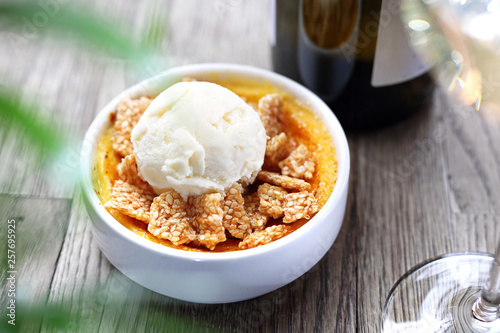 Dessert of cream brulee with ice cream and sesame in caramel.