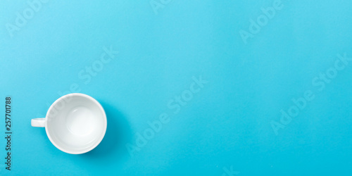 A coffee cup on a blue paper background