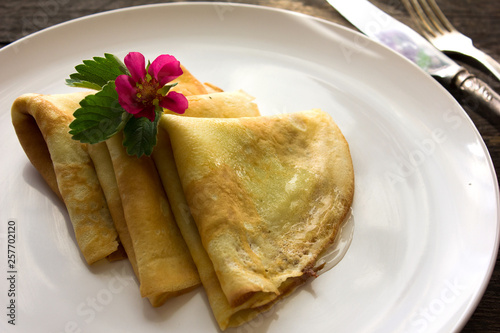 Tasty crepes with caviar. French crepes, russian or ukrainian on white background. Maslenitsa holiday food photo