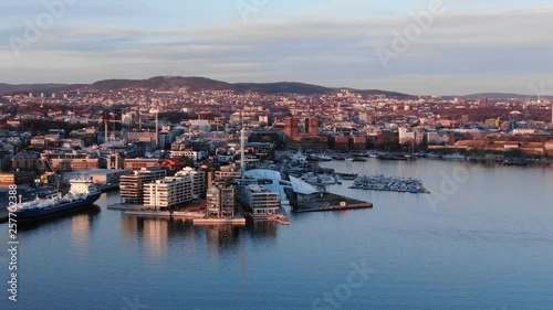 Aerial real time POI shot of Aker Brygge and Filipstad seen towards City Hall in Oslo, Norway at sunset in spring 2019