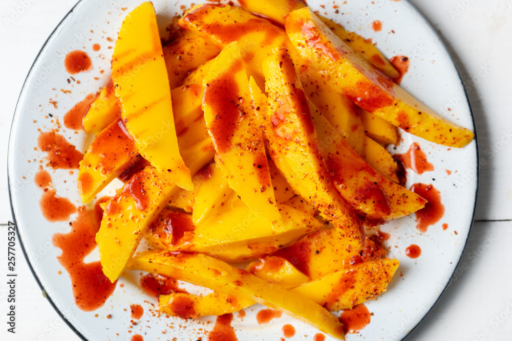 Mexican mangoes with chili powder and chamoy Stock Photo | Adobe Stock