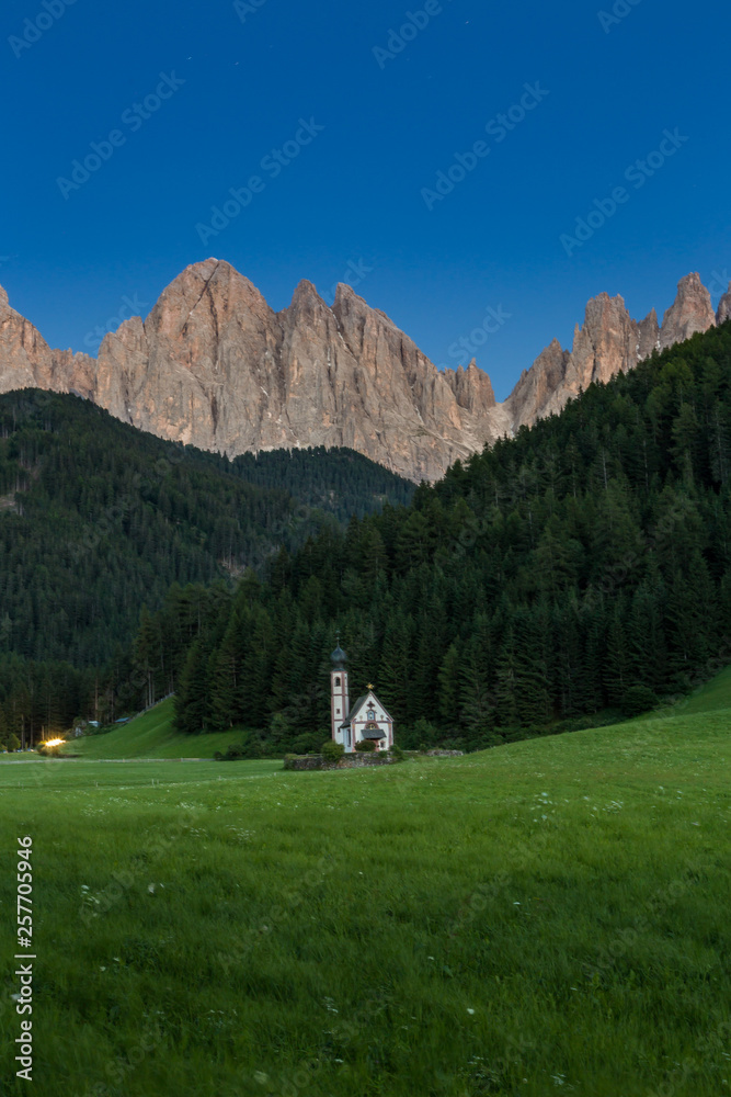 Tiny Church of San Giovanni in South Tyrol’s Val di Funes in front of Dolomite mountain, Italy
