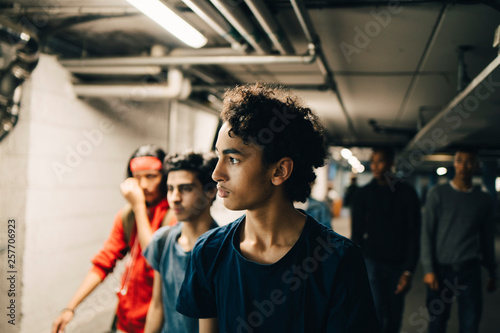 Teenage boys walking in basement photo