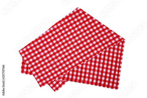 Closeup of a red and white checkered napkin or tablecloth isolated on white background. Kitchen accessories.