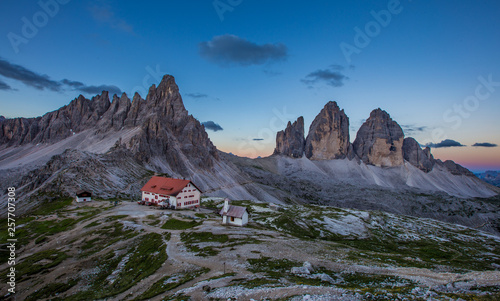 Panoramic view of Tre Cime and rifugio hut before sunrise in summer, Tre Cime di Lavaredo National Park, Dolomites, Italy