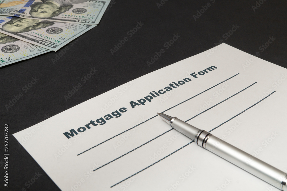 Mortgage with money and pen on black background. Mortgage with money and pen on black background.
