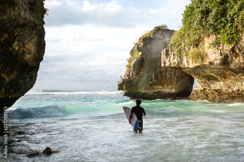 surfer guy goes to sea with a surfer board