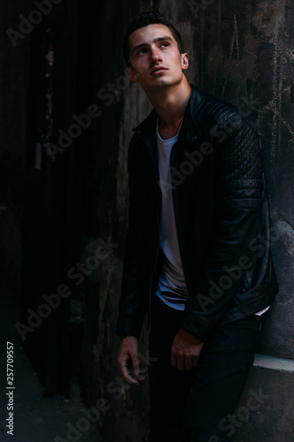 Attractive, sexy guy standing on the street in sunglasses. self-confidence, flatulence and arrogance. model, posing, portrait of a young man