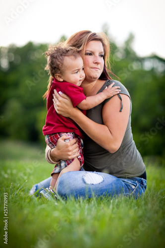 Happy Mom Holding Toddler Son Outside - Color Portrait