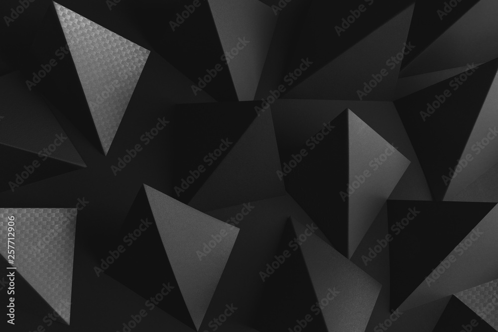 Fototapeta premium Dark background with black triangular elements of paper, abstract