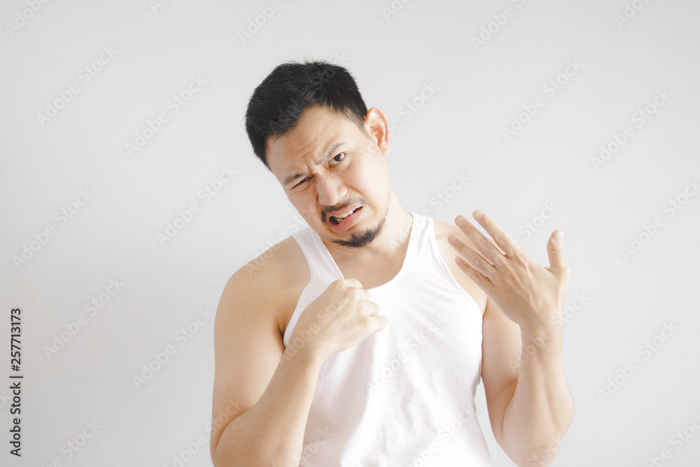 Man in white tank top with hot weather expression. Concept of hot weather of the sun in Asia. Man in white tank top with hot weather expression. Concept of hot weather of the sun in Asia.