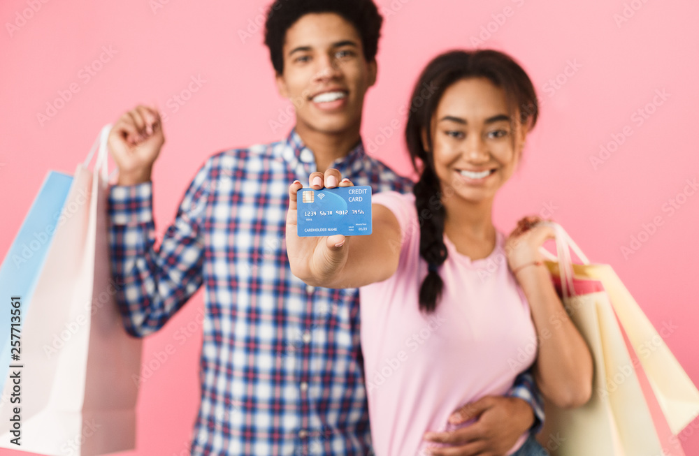Teenage couple with shopping bags and credit card Teenage couple with shopping bags and credit card