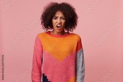 Fotografie Emotional african american woman with afro hairstyle looking at something terrib