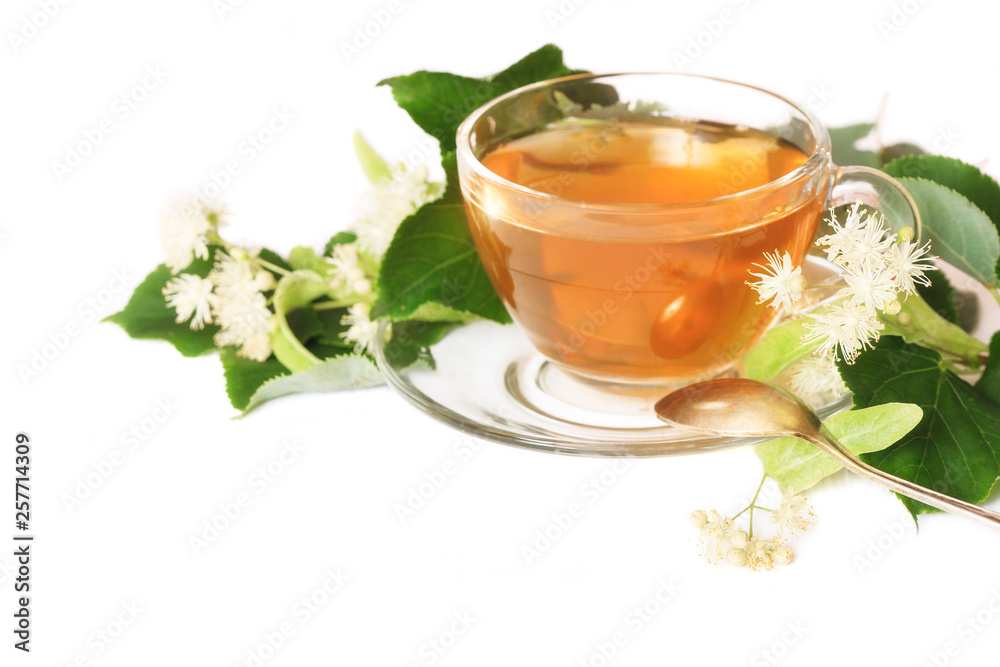 Linden tea on a white table in a glass cup. Flower tea, herbal medicine Linden tea on a white table in a glass cup. Flower tea, herbal medicine