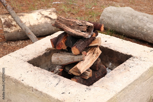Stacked firewood inside a fire pit. 