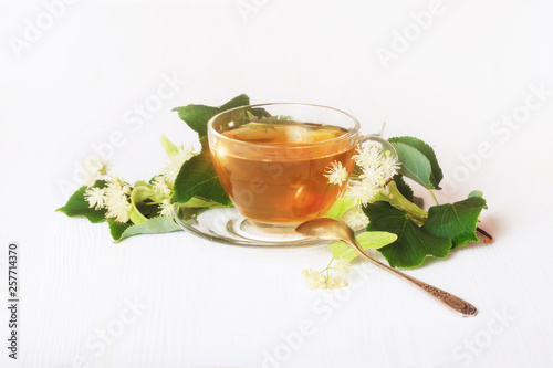 Linden tea on a white table in a glass cup. Flower tea, herbal medicine