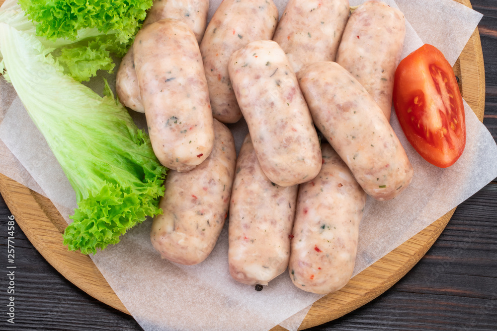Fresh raw sausage on the wooden background, top view Fresh raw sausage on the wooden background, top view