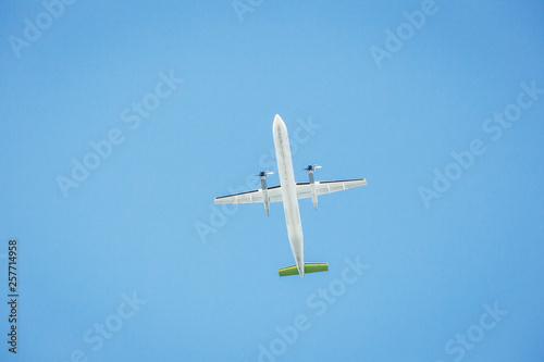 Passenger airplane isolated against the blue sky. Front view.
