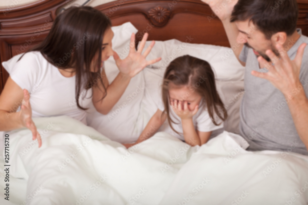 The concept of family conflict. Angry annoyed mother and father shout at crying daughter. Out of focus The concept of family conflict. Angry annoyed mother and father shout at crying daughter. Out of focus