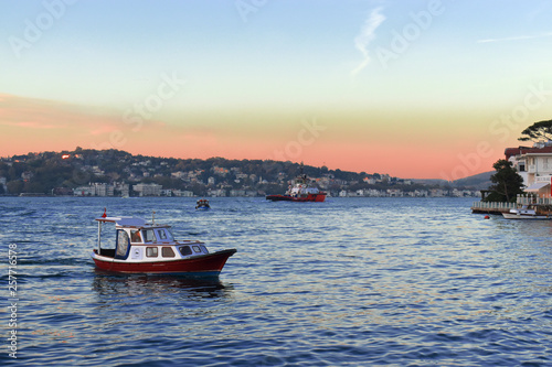 fishing boat in Istanbul Strait. sailing boat at sunset.