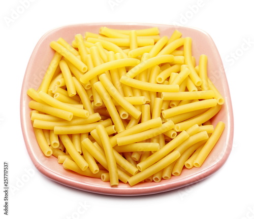 Macaroni raw pasta in porcelain bowl isolated on white background
