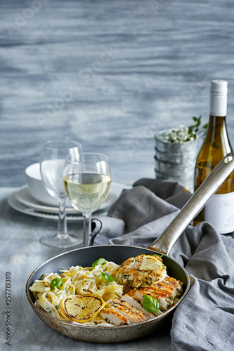 Pasta dish with grilled lemon chicken served with white wine