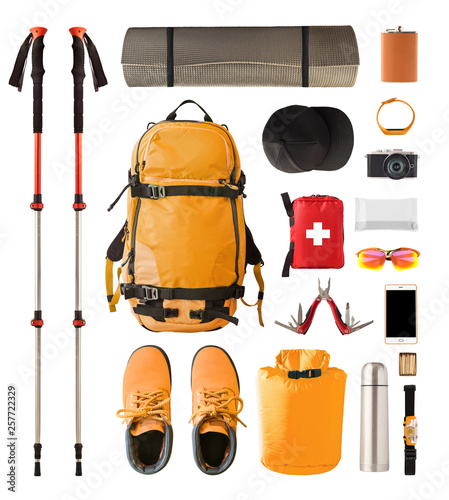 Set of sport equipment and gear for hiking and trekking. Top view of walking sticks, backpack, clothes etc. isolated on white background