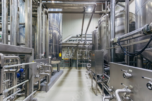 Industrial stainless steel vats in modern brewery 