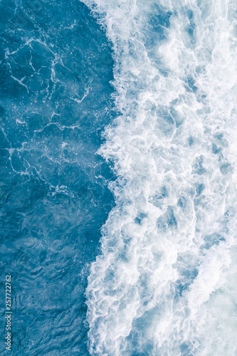 Pale blue sea wave during high summer tide, abstract ocean background