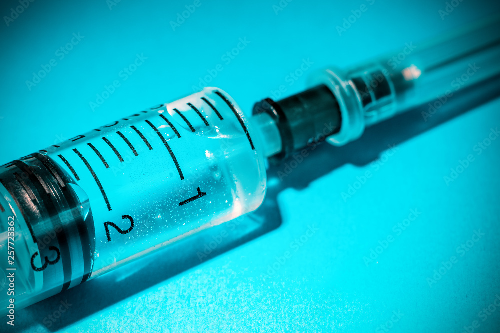 medical syringe on blue background medical syringe on blue background