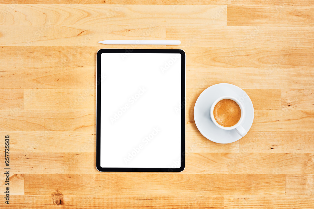 Digital tablet with blank white screen, pen and cup of coffee on wooden office desk. Top view. Copy space for text or design. Flat lay. Digital tablet with blank white screen, pen and cup of coffee on wooden office desk. Top view. Copy space for text or design. Flat lay.
